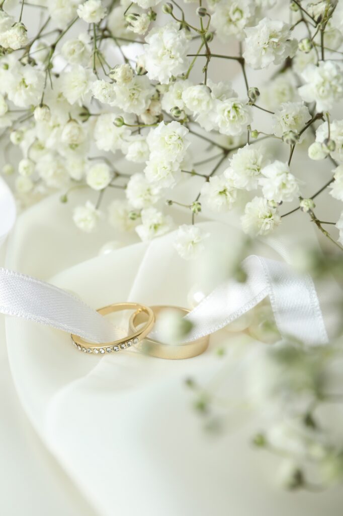 Concept of wedding accessories with wedding rings, close up