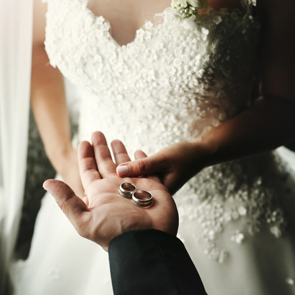 wedding couple holding luxury wedding rings